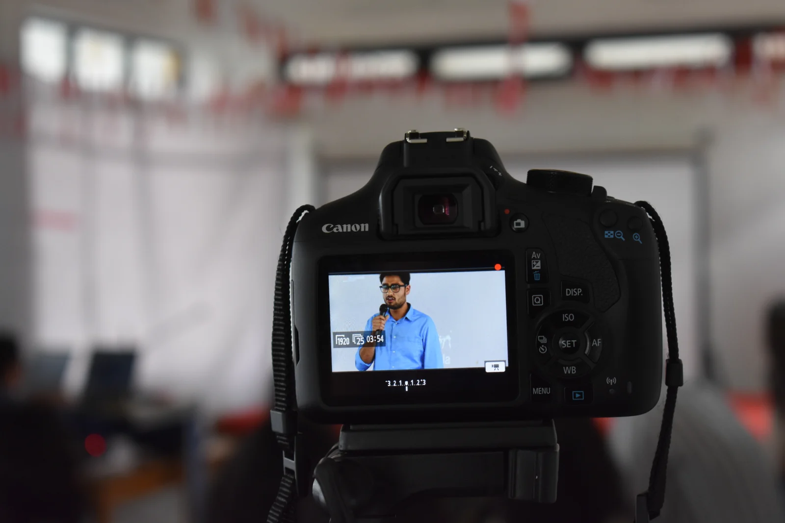 A camera recording a speaker at the 2018 salon