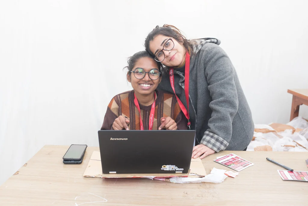 Two volunteers together at the welcome desk