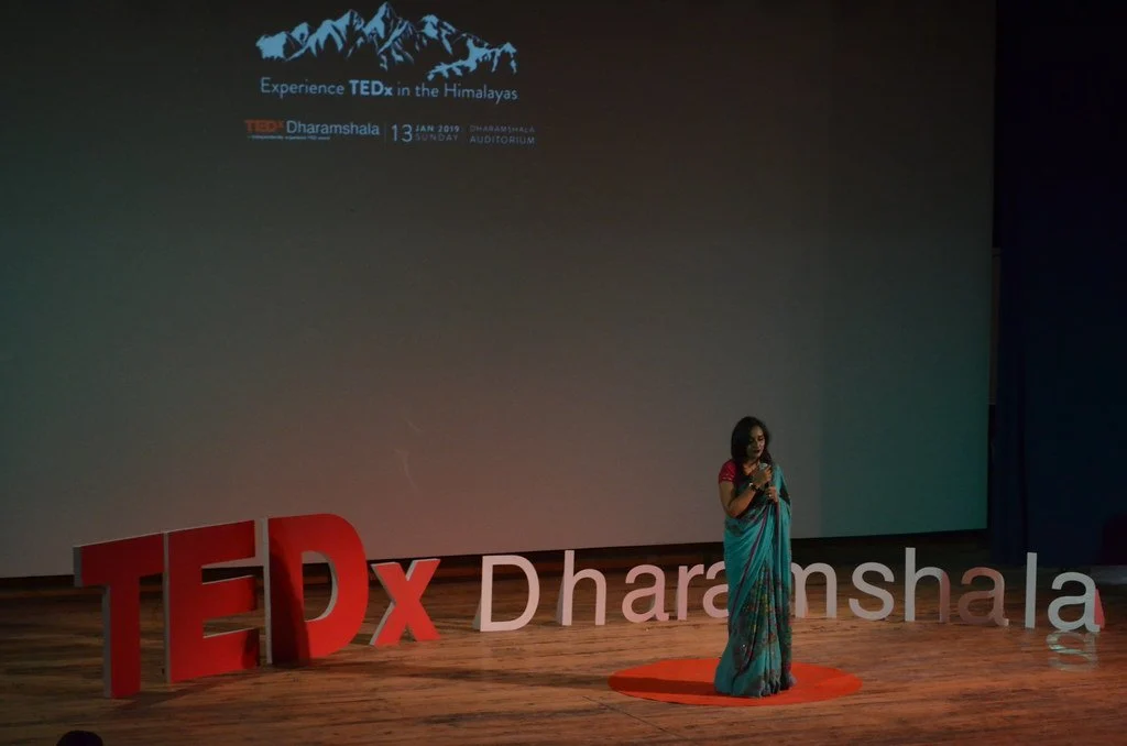 A speaker on the TEDxDharamshala stage
